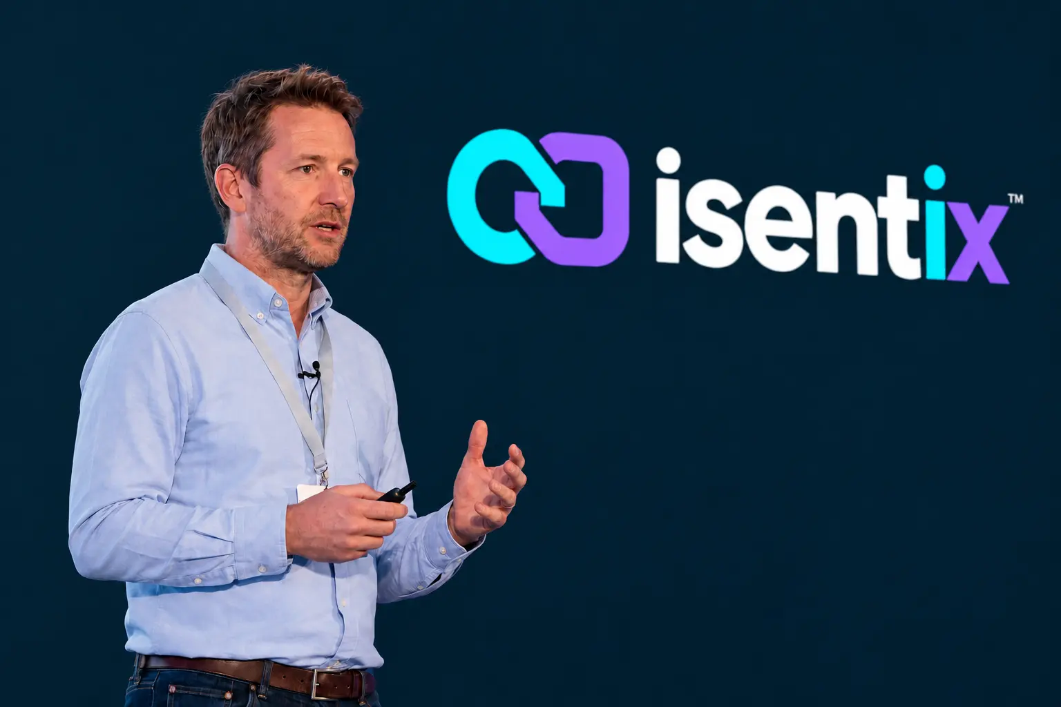 Speaker presenting beside the Isentix logo against a navy backdrop